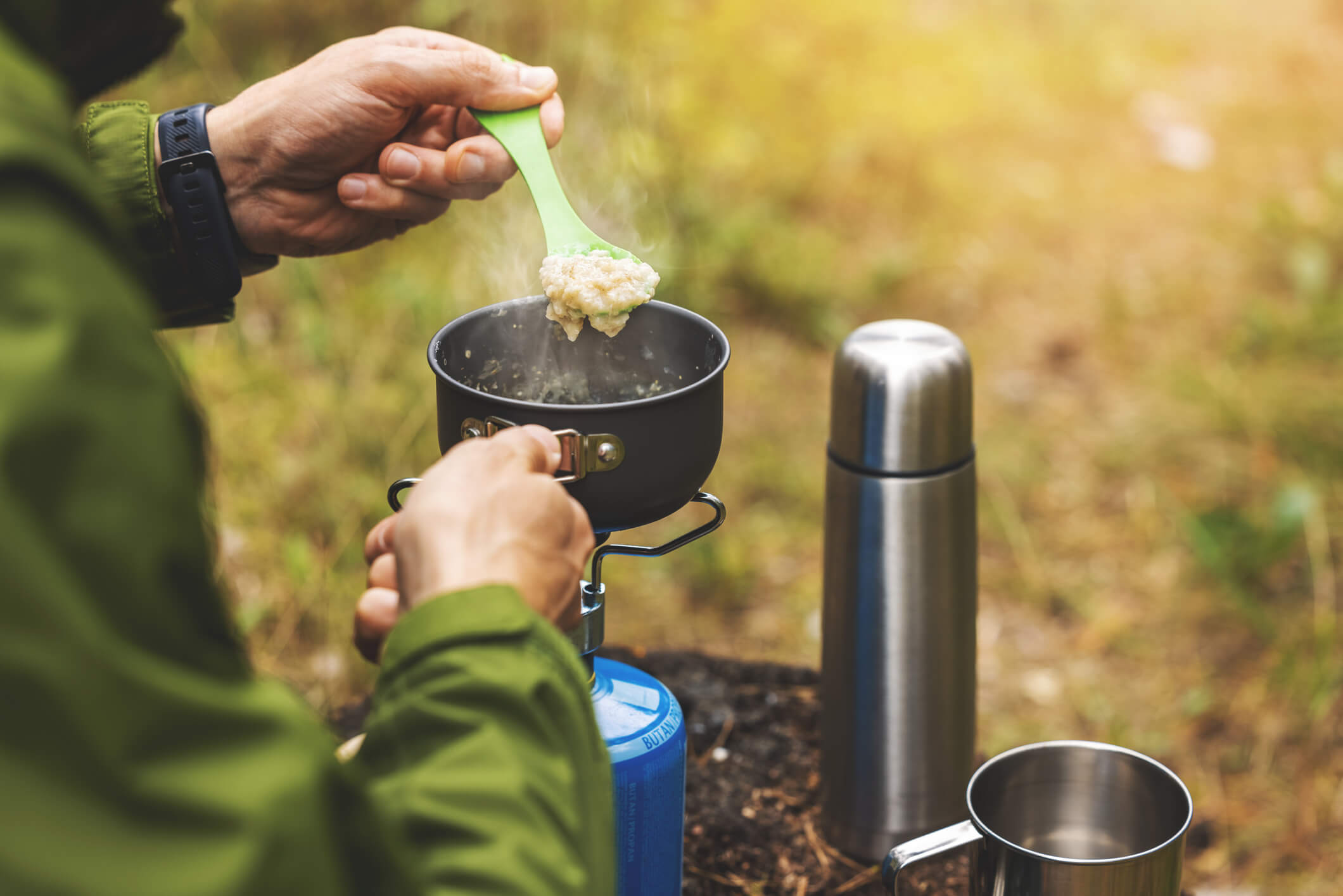 a father cooking a camping meal on a portable stove gift