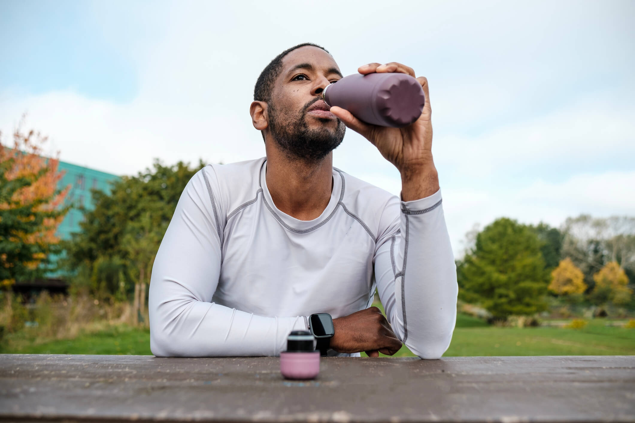 a father drinking from his insulated water bottle he got on Father's Day