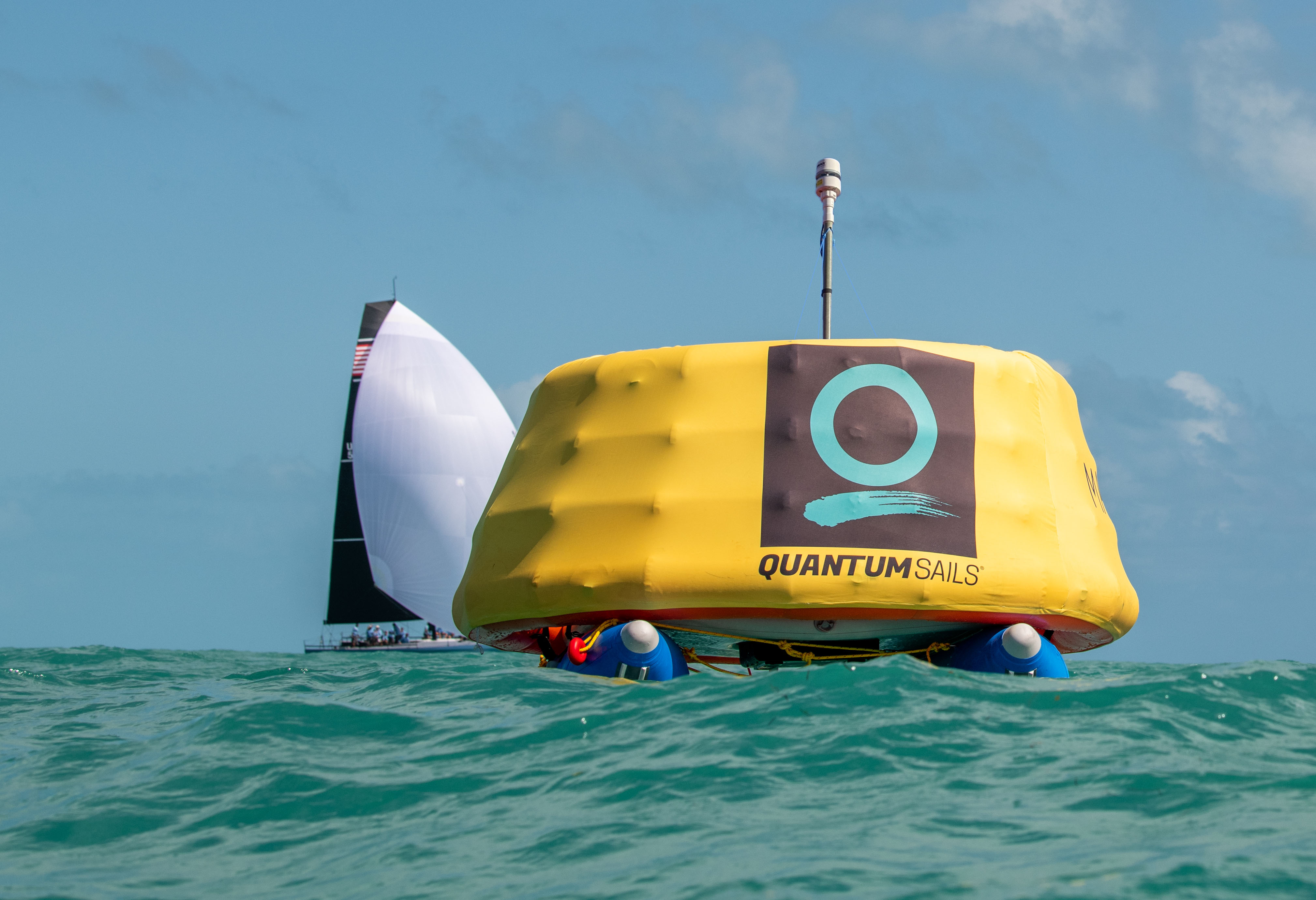 A Sailing Robotics Venture MarkSetBot floating in the ocean near a sailboat