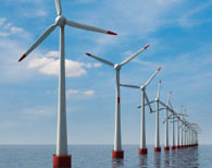 Multiple wind turbines lined up in the ocean
