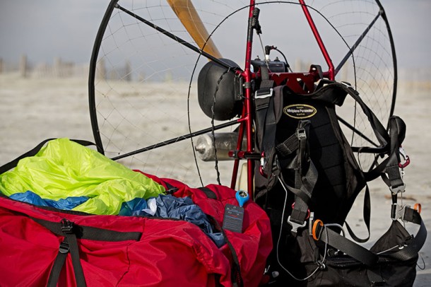 A paramotor sitting on a beach with a smartphone using the Tempest WEATHERmeter