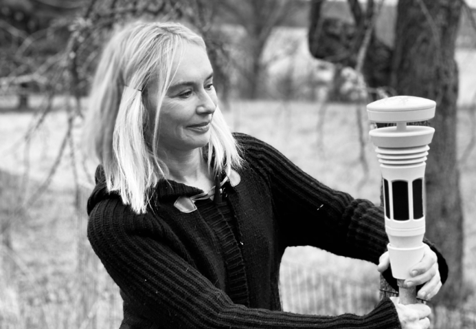 A women mounting the Tempest Weather Station on the Tempest universal mount